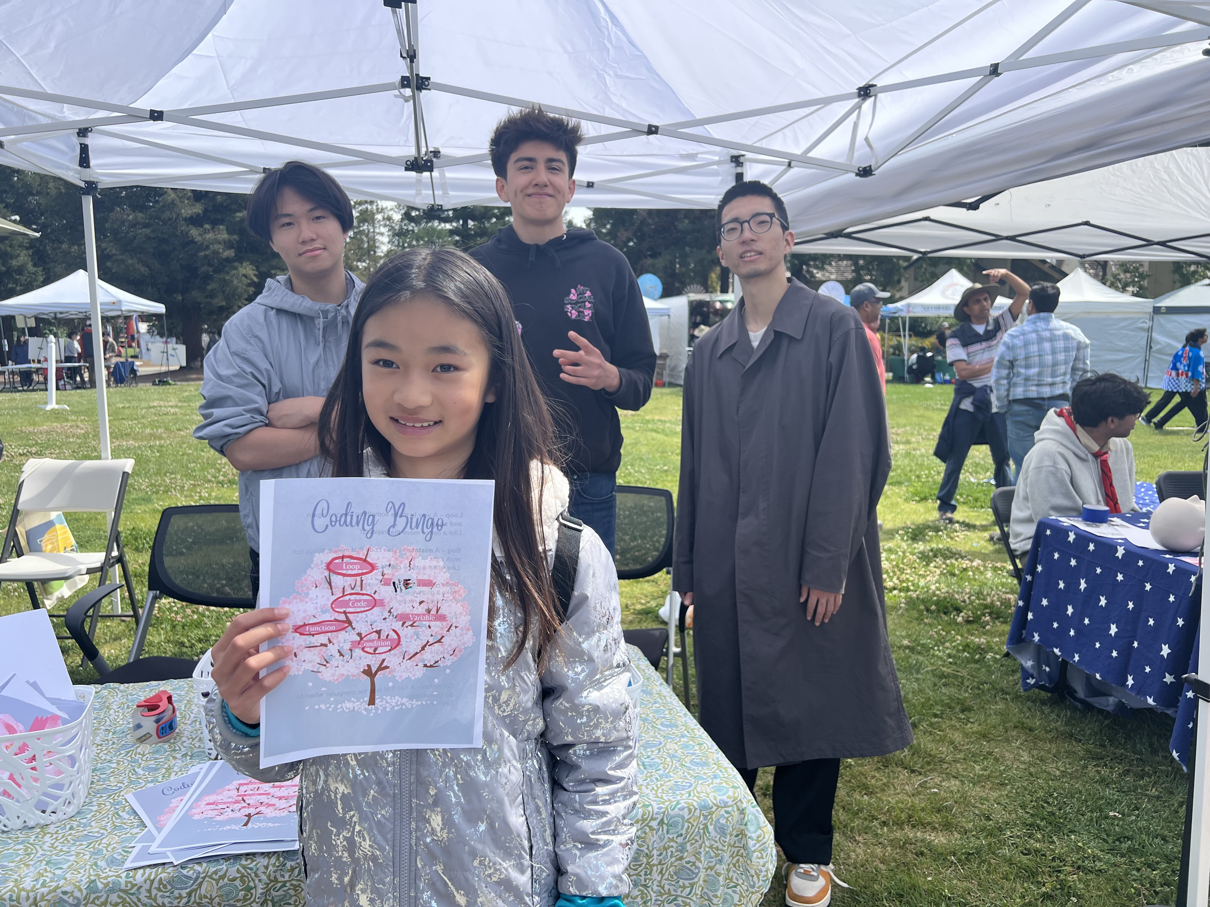 Student showing coding bingo activity at community event
