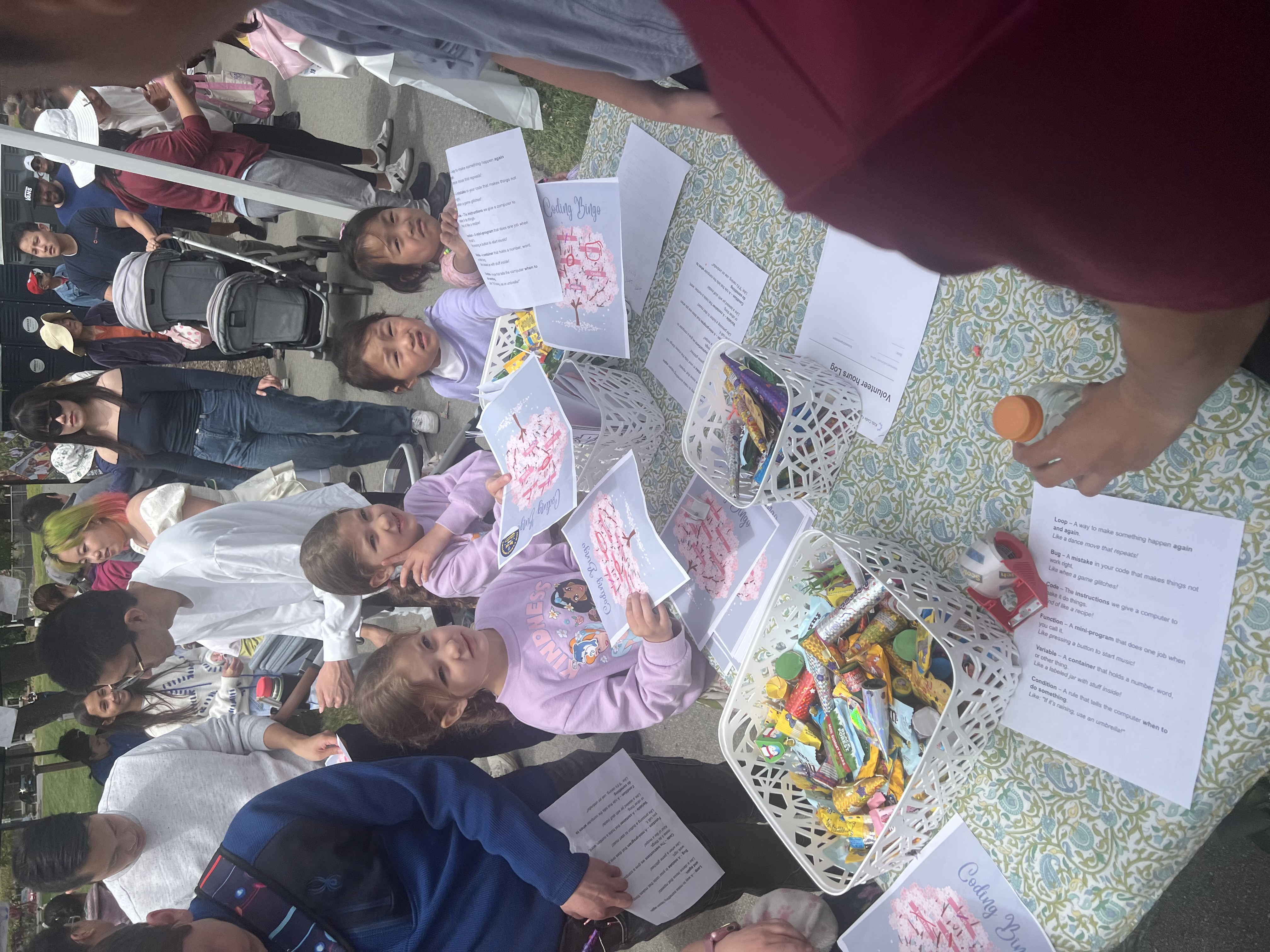 Children participating in coding activities at community event